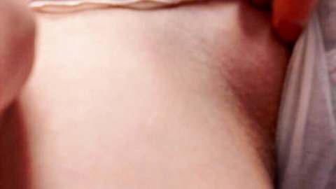 Closeup of woman's hairy pussy exposed with panties pulled aside spreading legs wide