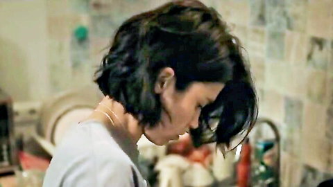 Russian brunette with short hair in white top, profile view from Khozyain 2023 movie scene