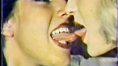 Two blondes in passionate French kiss, retro lesbian scene from Pussycat Film