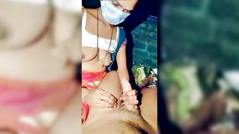 Indian aunty in mask stroking man's cock in explicit handjob