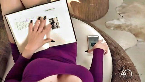 Aletta Ocean lounging seductively in purple dress, teasing cleavage while reading