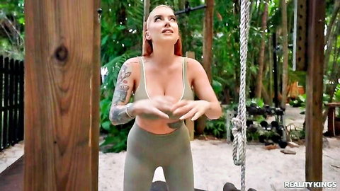 Cubbi Thompson teasing in tight gray tank top and leggings, redhead with tattoos