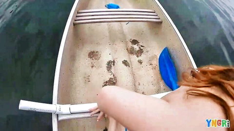 Amber Addis topless redhead masturbating with dildo in canoe outdoors