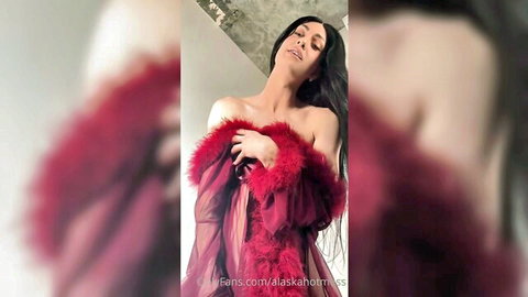 Seductive brunette exposes her huge bare tits in sheer red feathered robe