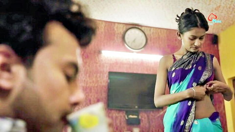 Sexy Indian bhabhi in purple sari adjusting blouse, teasing man with milky tea vibe
