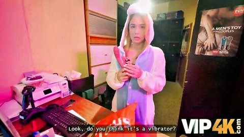 Rika Fane in fluffy pink bunny onesie holding pink vibrator, playful tease