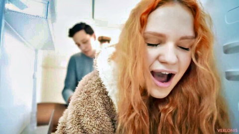 Redhead girl stuck in fridge with stepbrother behind her, surprised expression