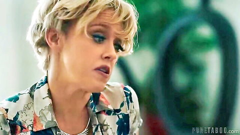 Blonde woman with short hair in floral blouse, surprised expression