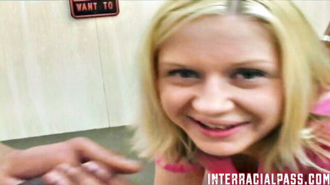 Smiling blonde teen in pink top teases close-up for interracial blowjob