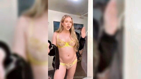 Cadence Caliber teasing seductively in yellow lingerie, blonde beauty