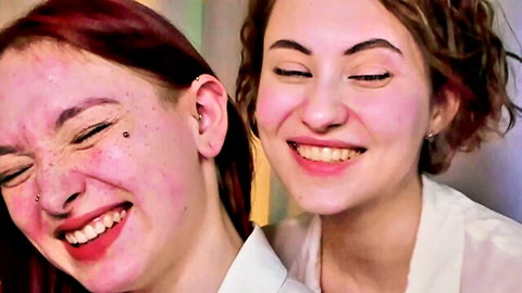 Lina and Kitty redhead couple smiling playfully in Chaturbate show
