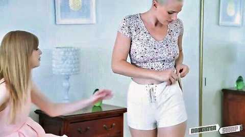 Young blonde teen reaches for her hot friend's white shorts waistband in teasing bedroom moment