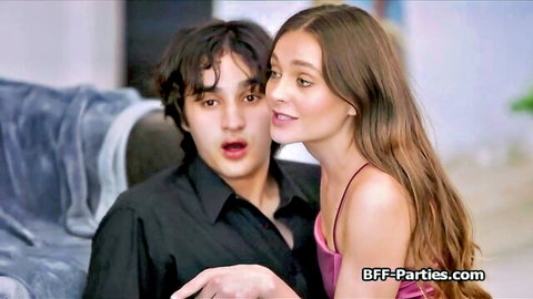 Flirty brunette teen in pink top teases surprised guy on couch at party