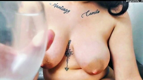 Pregnant Latina MILF with huge lactating tits holding glass against her bare swollen nipples