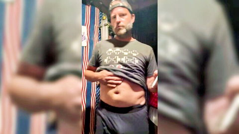 ChefHector1 posing in gray t-shirt and shorts, showing belly