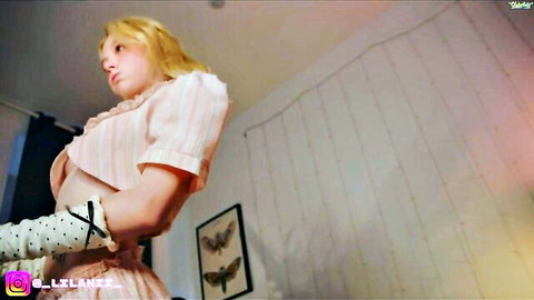 Blonde cam model little_anitta in pink striped dress and gloves, seductive pose
