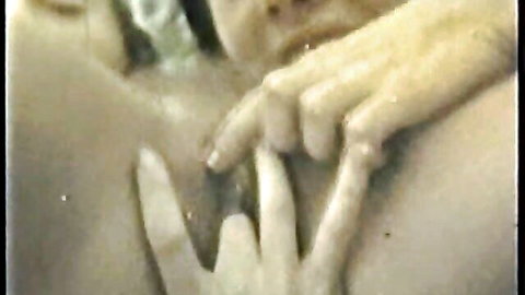 Retro vintage porn close-up of woman's ecstatic face with hand squeezing bare breast