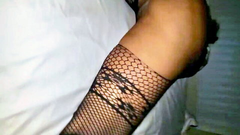 Black MILF arm in sexy fishnet sleeve on bed, cheating vibe