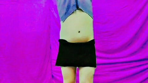 Sexy trans woman dancing in crop top and mini skirt under fairy lights