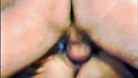 Closeup of mature woman's spread pink pussy with reddish tampon protruding from vagina