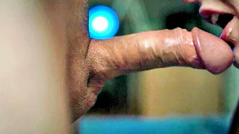 Close-up erect cock in condom near red lips, quick cumshot tease