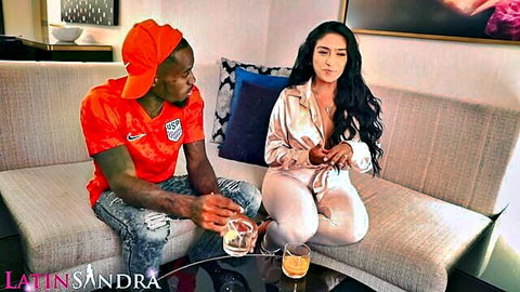 Curvy Latina brunette in shiny satin pants and cleavage top teases muscular BBC guy in soccer jersey on hotel couch