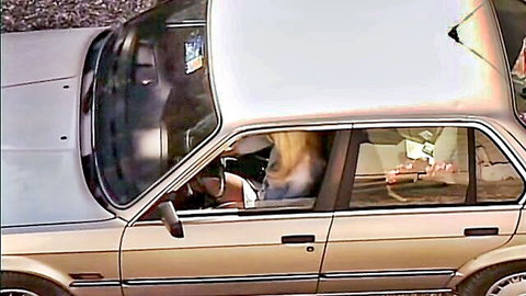 Blonde woman hikes up skirt flashing thighs in vintage BMW car