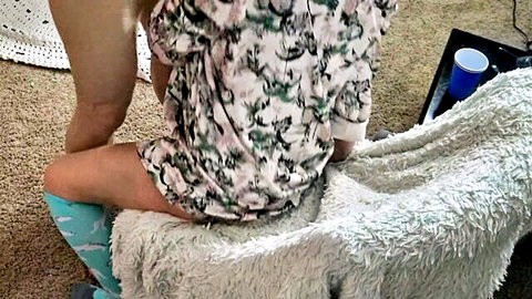 Blonde amateur in short patterned dress teases big ass sitting on fur stool looking back