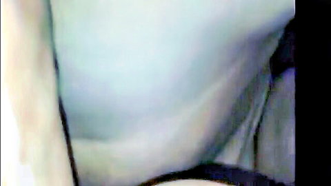 Pale-skinned woman posing nude with visible breast