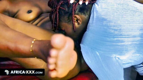 Busty African babe with braids topless, exposing curves and sexy feet