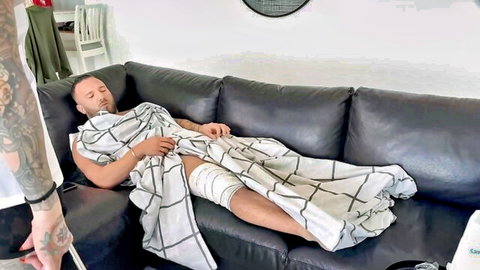 Lena Love caring for bandaged male patient on couch in medical roleplay