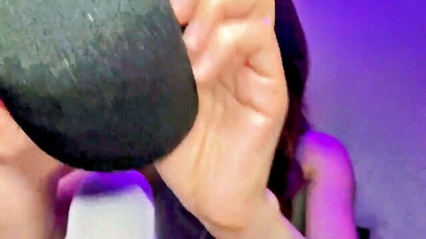 Lin ASMR mic pumping close-up, hand gripping black microphone for tingles