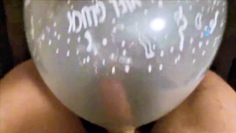 Blonde woman presses silver balloon to crotch in solo balloon fetish tease
