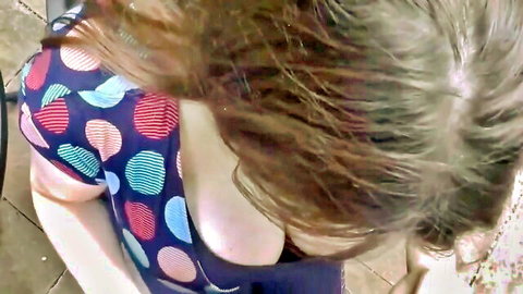 Busty brunette in polka dot dress showing deep cleavage in POV