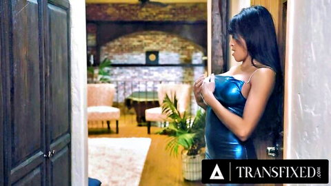 Ember Snow in shiny blue dress, seductive lean with cleavage tease