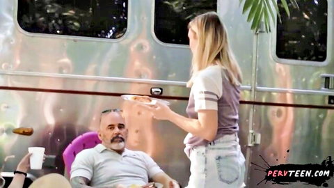 Blonde booty teen in shorts serves food to older man outdoors by RV