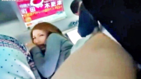Asian woman with red hair in intimate public bus encounter