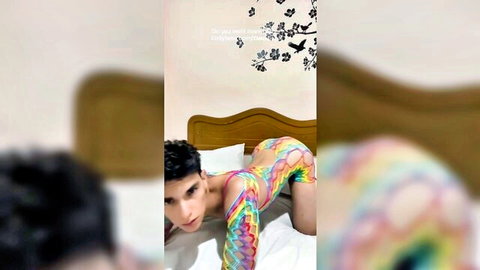 Hot guy in colorful fishnet lingerie doggy style on bed showing off his tight ass