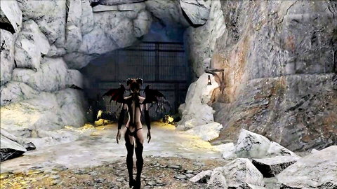 Demon girl with black wings and horns exposes bare ass in skimpy harness inside dark cave cosplay.