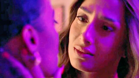 Intimate lesbian embrace between two women in dramatic purple lighting, emotional close-up