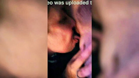 Blurry close-up of intimate tongue kiss between two women
