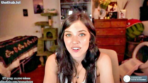 Emma Choice smiling in low-cut top during cam show, teasing cleavage