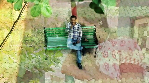 Indian man in plaid shirt and jeans sits on bench in erotic MILF movie scene