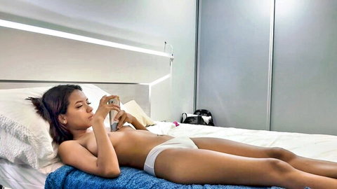 Karol Loves topless on bed, perky tits exposed, white panties, slim latina body