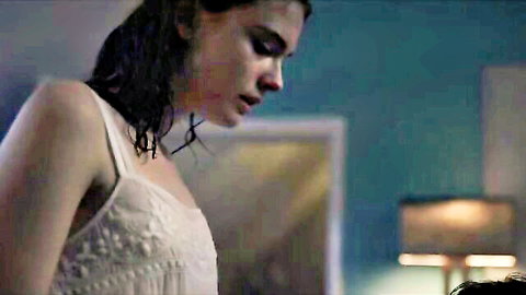 Wet brunette in sheer lace slip dress teasing small tits in steamy bedroom scene