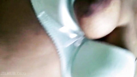 Close-up of South Asian woman's exposed wet pussy and labia in sheer white panties with thigh tattoo
