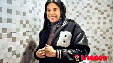 Amanda Luxor, Cuban Latina smiling in varsity jacket