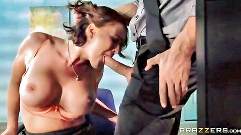 Busty brunette topless with big tits exposed kneels for office blowjob guided by man's hand