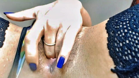 Woman with blue nails spreads her hairy pussy lips wide exposing wet pink vagina