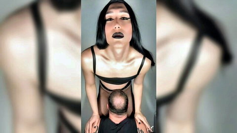 Dominant Asian woman in black lingerie deepthroating man while smoking cigarette